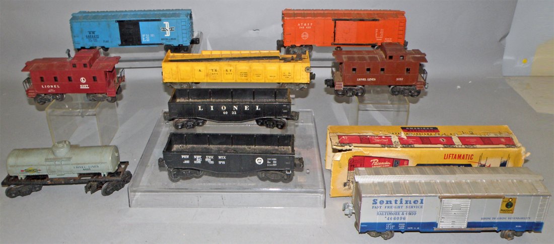 LOT OF LIONEL FREIGHT CARS: Includes boxed American model B&O Sentinel., box - fair. Lionel #6037 Caboose, B&M Freight car, AT&SF box car, AT&SF mechanical loader, PRR hopper and Lionel #6032 Hopper, #6357 Caboose, #6035 Tanker.