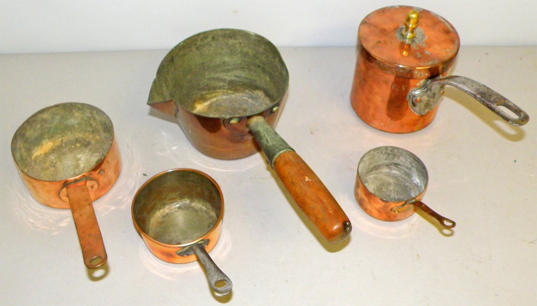 FIVE SMALL ANTIQUE COPPER COOK POTS: One with original lid, one with dove tail construction largest 11 1/2" long