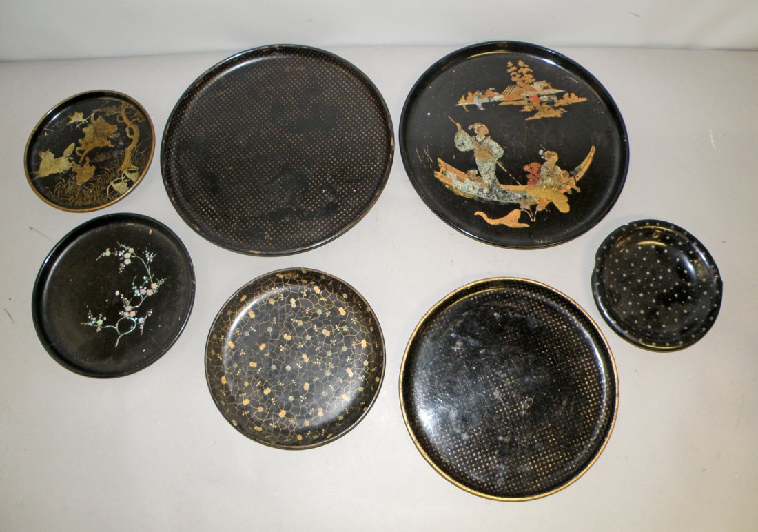 SEVEN PAPIER-MACHE TRAYS: Show surface wear. Smallest has rim damage. largest 12" diameter