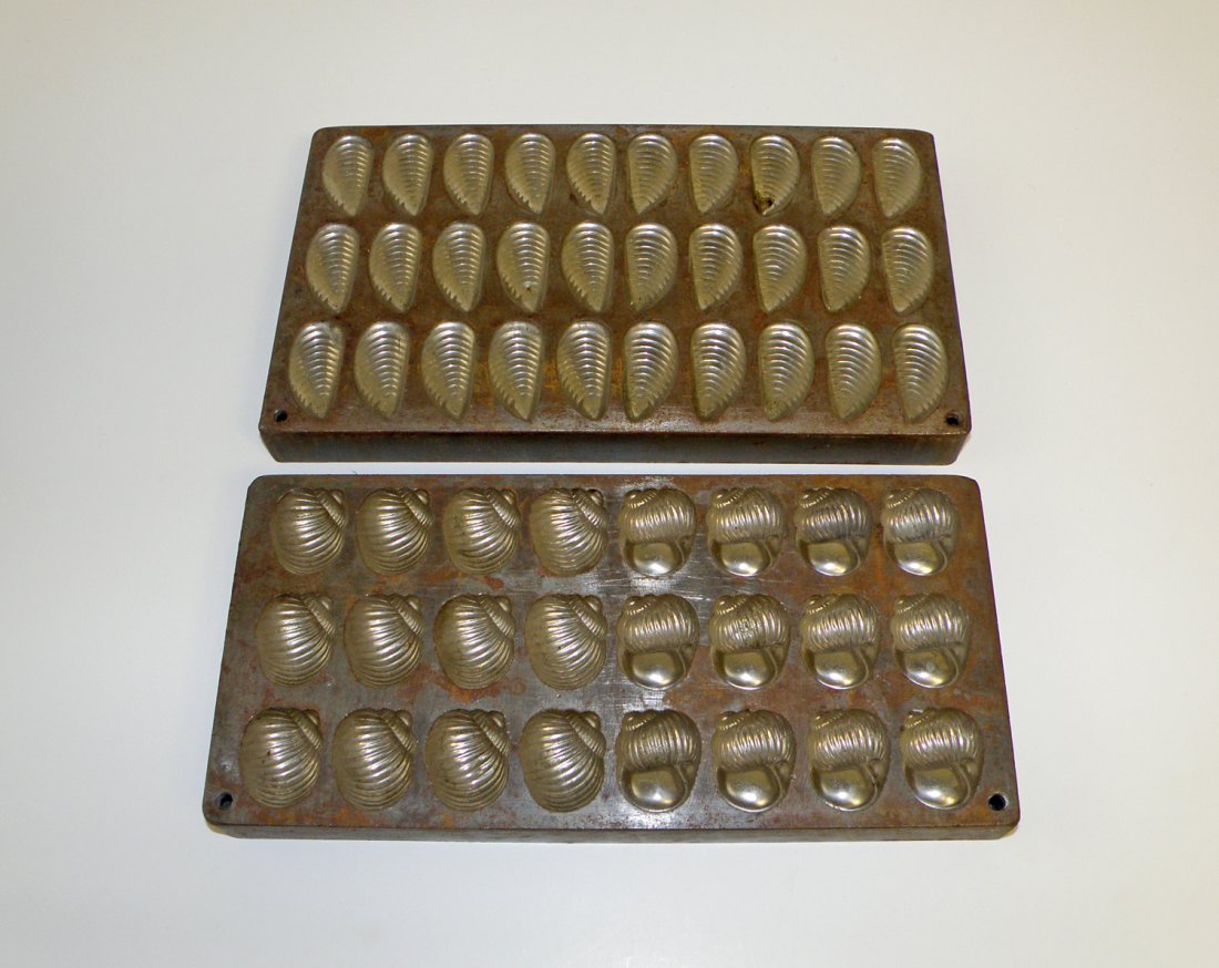 TWO CHOCOLATE MOLDS: Both are of different shells. Circa 1930. largest 105/8" x 6"