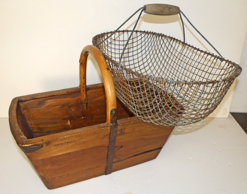 PAIR OF ANTIQUE BASKETS: Wire egg basket and a dove tailed wood egg basket with iron straps. largest 20" long