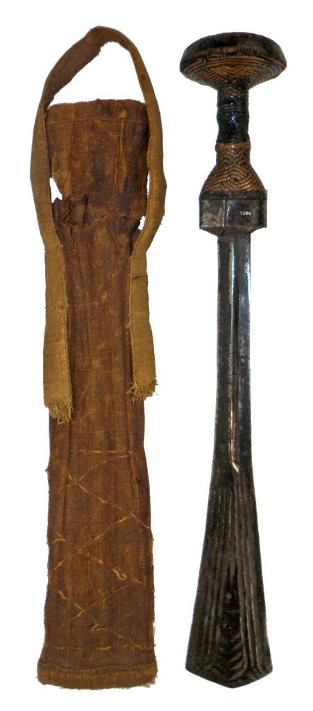 ANTIQUE SWORD AND SHEATH FROM DRC: Late 19th century sword with hand forged iron blade, carved wood handle with hammered copper inlays. Old museum inventory number 7394. Includes original woven sheaf. Sheaf has some damage. Sheaf- Fair