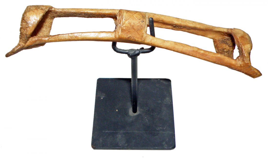 INDONESIAN ASMAT WARRIOR NOSE BONE: Made from carved bone. Shows signs of age and wear. Comes from the Irian Jaya province of PNG. 6 5/8" long