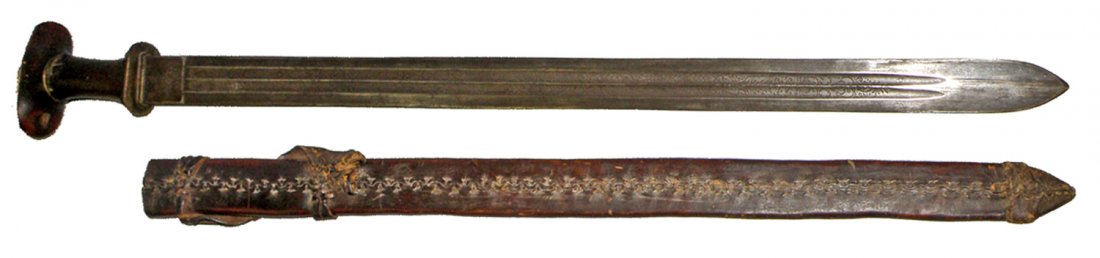 19TH CENTURY SWORD: Double fuller blade with acid etched decoration. European blade marked G.G.on ricasso. Other side with lion. Possibly by Luckhou & Gunther. Grip and scabbard probably from Nepal also 19th century. Min