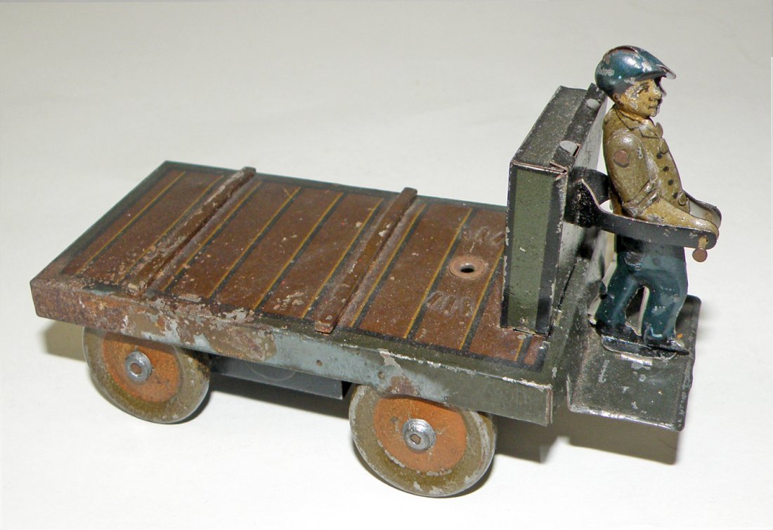 BING BAGGAGE CART: Tin windup has surface wear. 5 1/4" long