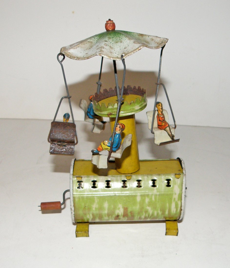 DISTLER MUSICAL CAROUSEL: Hand crank with Plink-Plink mechanism. Scattered light spotting. 7 1/2" tall