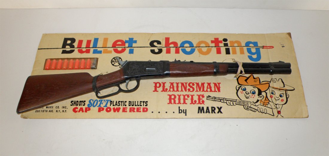 NEW OLD STOCK MARX PLAINSMAN RIFLE: Plastic bullet shooting rifle shoots bullets with cap firing action. One rubber band replaced. Some creasing to card. 24 1/2" long