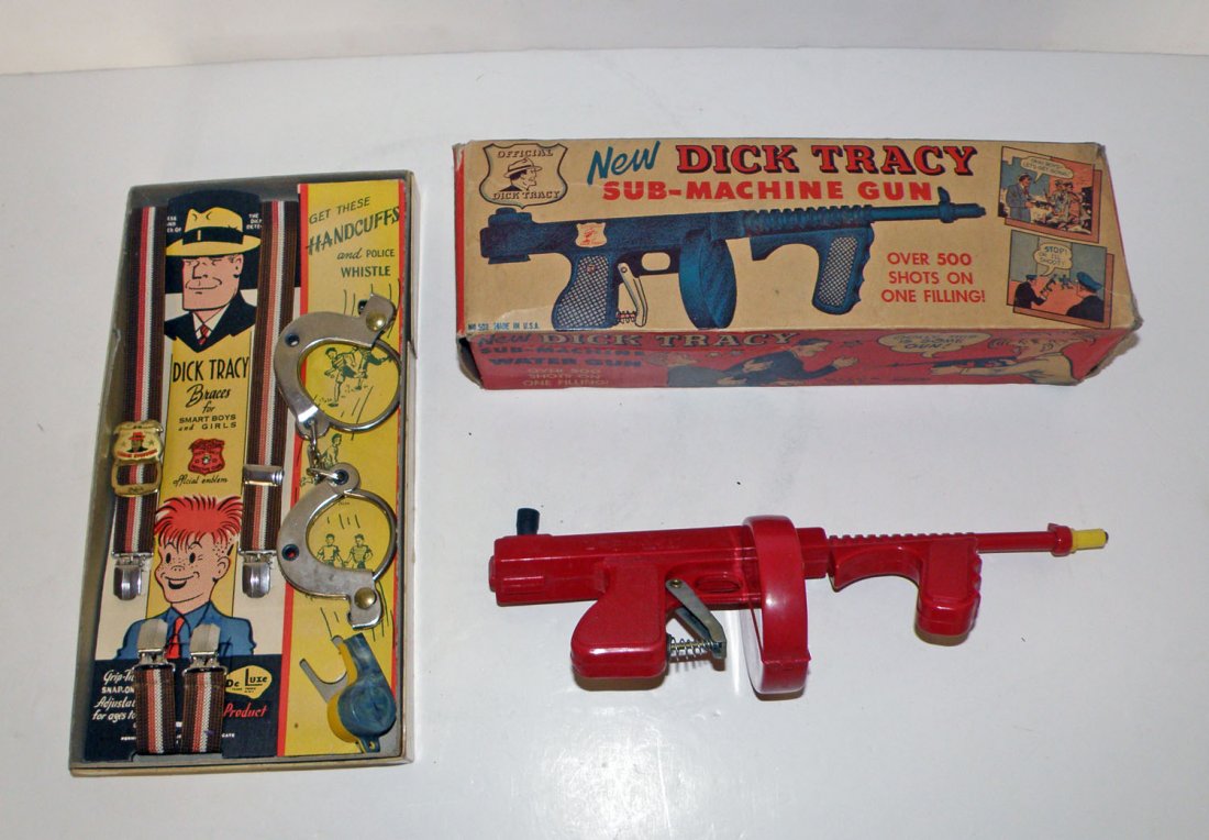 TWO BOXED DICK TRACY TOYS: Sub-machine water gun by Tops Plastics, complete box with some creasing. Braces and handcuff set in OB, some wear to box lid. Box Good - Fine Largest: 12 1/4" long
