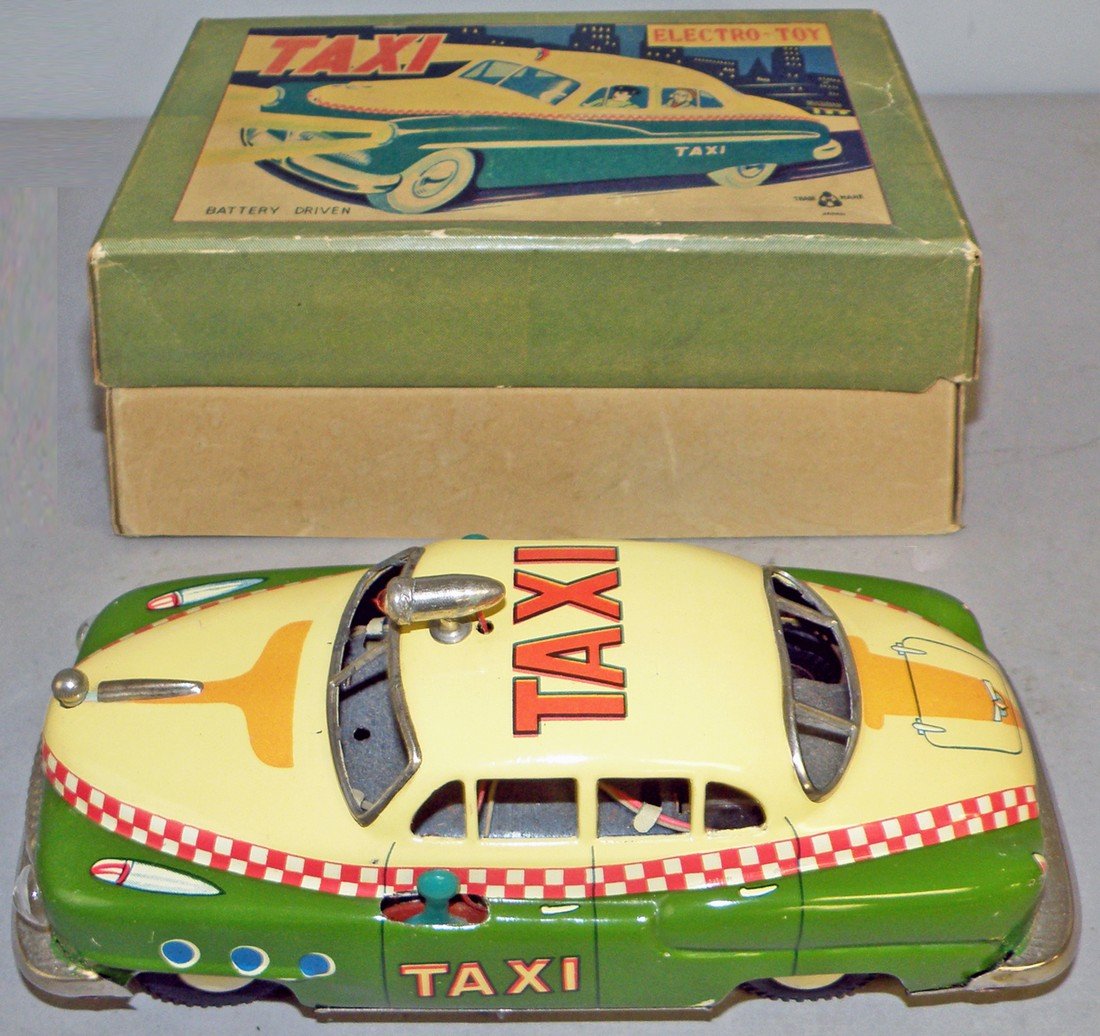 BOXED ELECTRO-TOY TAXI: Colorful 1950's battery operated toy. Works fine. Couple of spots of factory touch up. Original box has one puncture to lid. Box- Fine-VF 8 1/2" long