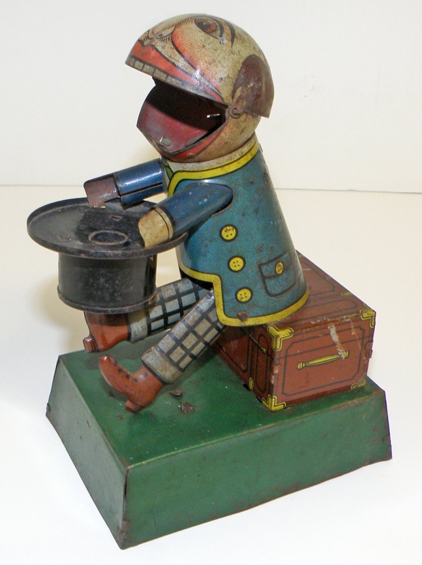 TIN WIND UP DUMPLING EATER BY HANS EBERL: German tin windup with comical action works fine with some wear and spotting. 6 1/4' tall x 4 1/2" deep