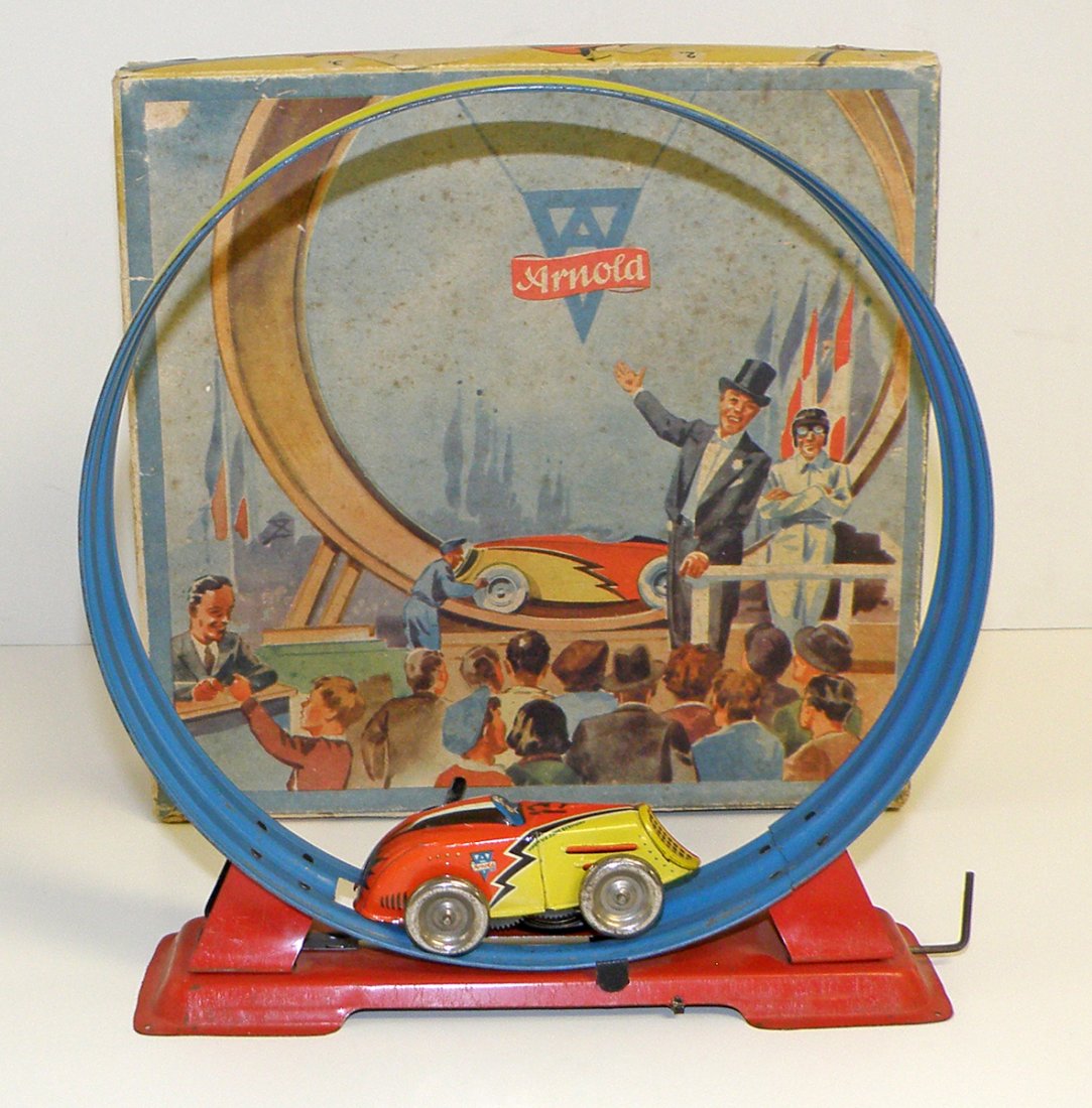 BOXED ARNOLD LOOPING CAR: Made in US zone Germany. Tin windup works fine with light playwear, car missing one wheel. Original box has some spotting and tears to lid. Box Condition: FINE 10" tall