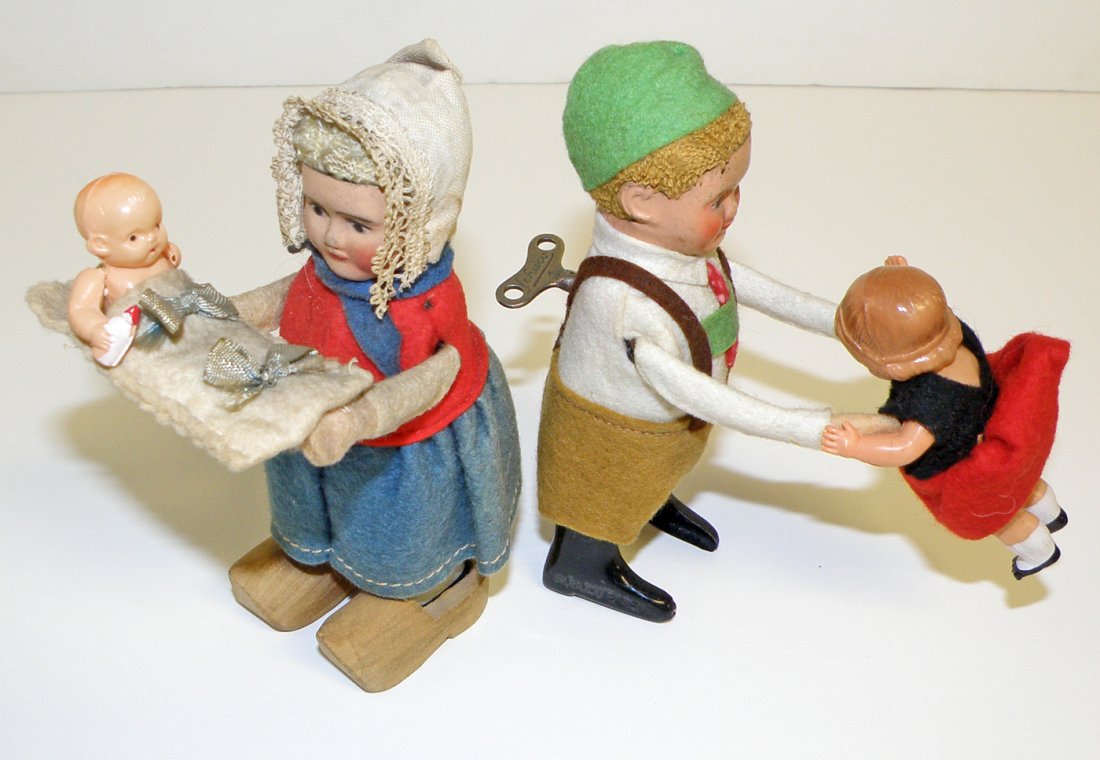 TWO SCHUCO WINDUP TOYS: Both pre-war versions, Dutch girl with baby and Bavarian boy dancer. Minor wear and working. 5" tall
