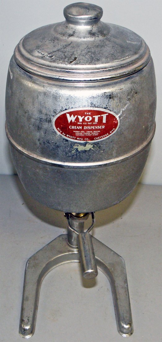 WYOTT CREAM DISPENSER: Soda fountain or coffee shop item. Surface wear. 21" tall