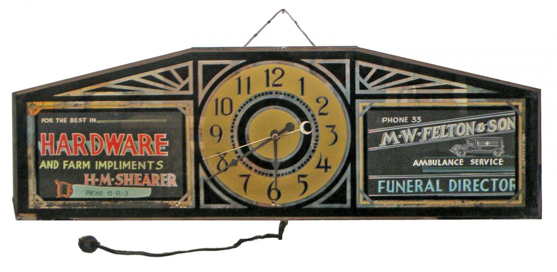 UNUSUAL 1930's REVERSE ON GLASS ADVERTISING CLOCK: Silver Lite Ad Clock features ad for H.M. Shearer Hardware and Farm Implements on left side and M.W. Felton Ambulance and Funeral Director on right. Scattered light paint loss, chip to lower left corn