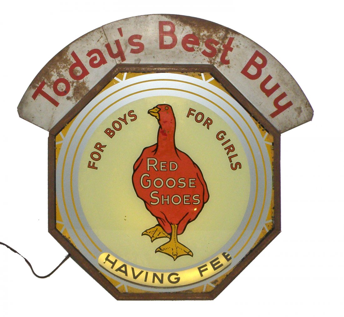 RARE RED GOOSE SHOES LIGHT UP SPINNER SIGN: Reverse on glass front with working spinner. Has original tin marquee. Original paper labels to reverse. Some scattered lifting and flaking to sign. 22" tall x 24" wide