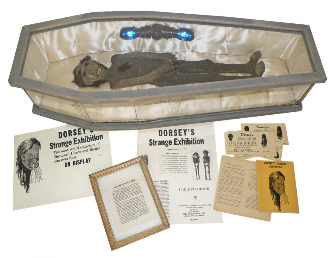 HOMER TATE SHRUNKEN BODY IN CASKET: From the Dorsey collection. Comes with documentation and original Dorsey paperwork. Comes in glass sided casket made by Dorsey's father that shows some wear. Casket is VF 32" long x 11 1/2" wide x 7" 