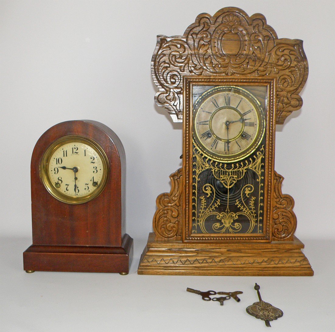 TWO MANTLE CLOCKS: Waterbury Pillsale model pressed oak carved clock. Seth Thomas dome top mantle clock. Both working, but not tested for accuracy. Largest 22" t