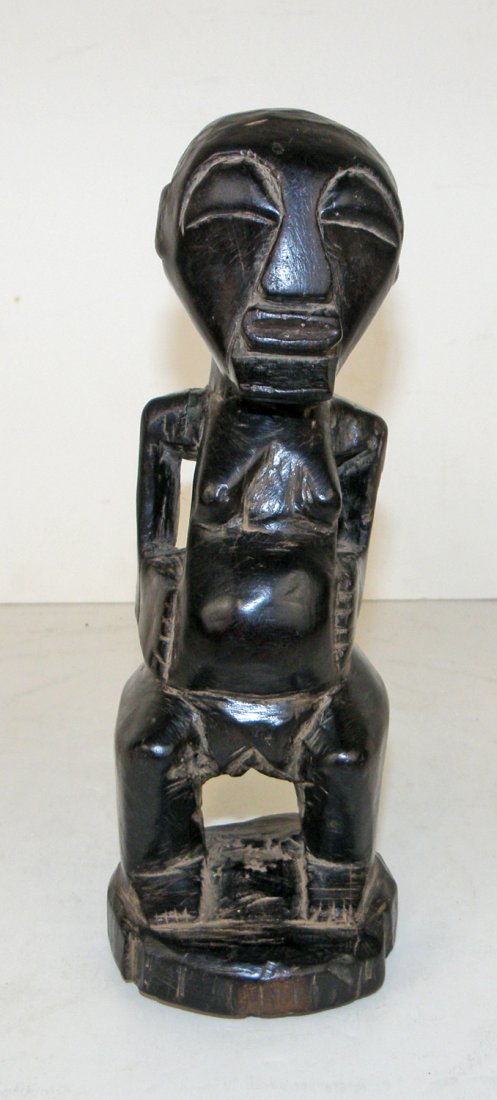 SONGYE POWER FIGURE: Ebony "pocket figure". Some age splitting to wood. Loss to back of base. 9 1/2" tall