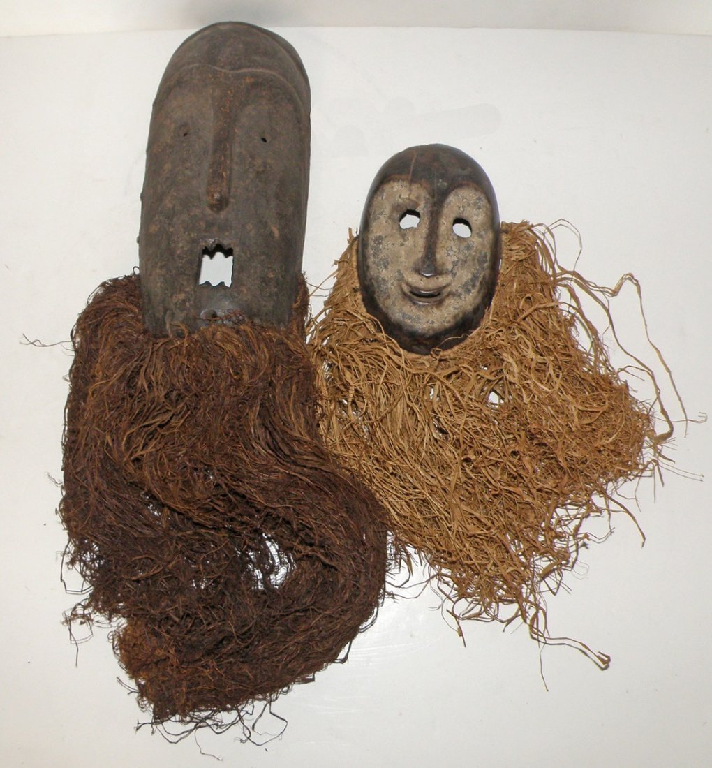 SONGALA & PERE PASSPORT MASKS: DRC, both people live in the Ituri Rainforest area. Light surface wear. Old staple repair to one side of larger mask. Largest 13" tall