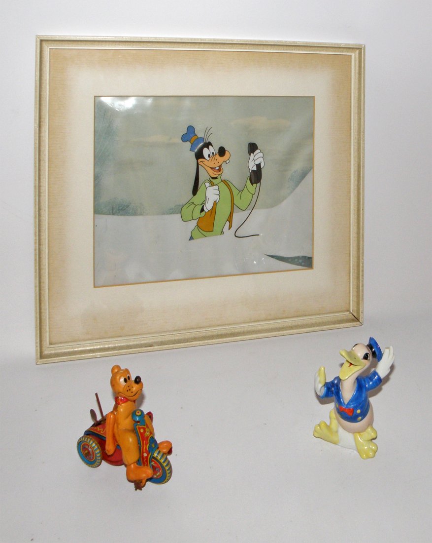 CHARACTER TOY LOT: Includes a Disney Art Corner cell of Goofy, a 1930's Donald Duck toothbrush holder, and a Linemar Pluto tricycle. Largest is 14 3/4" x 12 3/4"