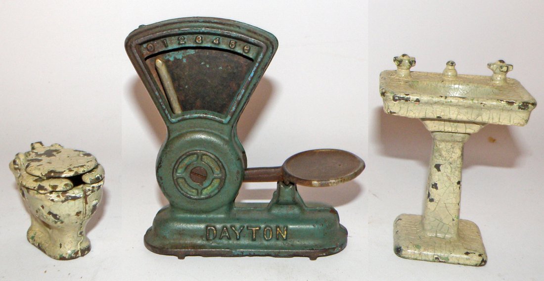 THREE CAST IRON TOYS BY ARCADE: Includes Dayton scale, toilet and sink. largest 4 3/4" tall x 4 1/2" wide
