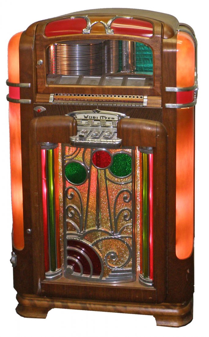 WURLITZER MODEL 700 JUKEBOX: Coin operated. Nice working example with older restoration, needs cleaning. Retains original coin mechanism, amplifier and speaker. Right upper corner lens has old crack. 55" tall