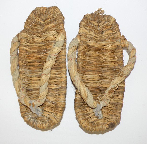 PAIR OF HAND WOVEN JAPANESE SANDALS: Woven from reed with some used cloth. Likely from one of the Japanese islands, but known. 8" long x 6" tall