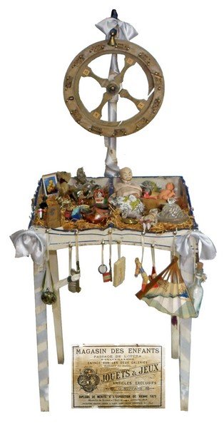 CHILD OR DOLL'S LOTTO GAME: French game from the store Magasin des Enfants. Retains original label. Most prizes are period and original, with a couple of later additions. Repairable wood split to wheel. 34 1/2" tall x 14" wide x