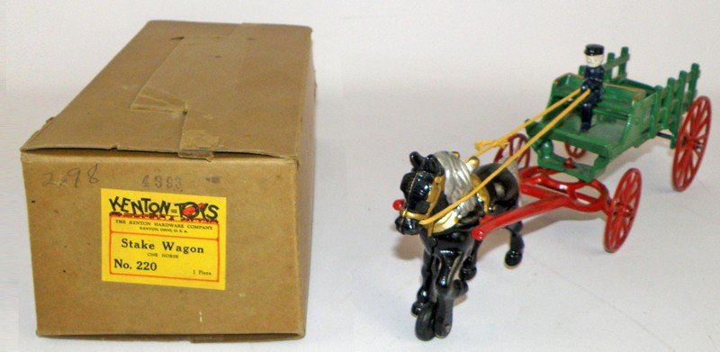 BOXED NOS KENTON STAKE WAGON: Kenton-Toys Model No. 220. Cast iron toy is unplayed with. Box wear only. Has original packing paper. Original box has some edge wear. Box is fine-VF. 14 1/2" long