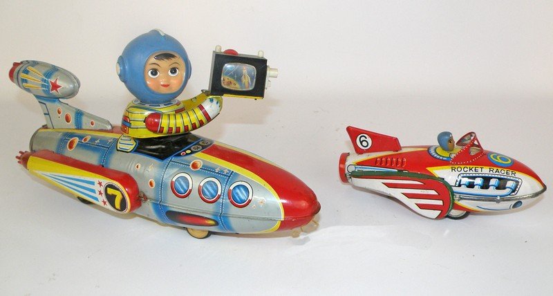 TWO RED CHINA SPACE ROCKETS: Battery operated T. V. Space Rocket and a friction rocket racer. Both show some play wear. Largest 14" long