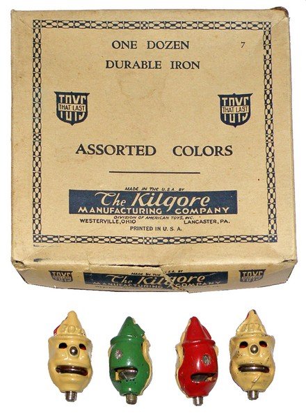 BOXED KILGORE CAST IRON CAP BOMBS: Original cardboard box retains four unused Clown cap bombs. Minor aging, chips. Box has wear, box VG-Fine