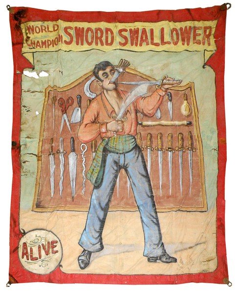 WORLD CHAMPION SWORD SWALLOWER BY FRED JOHNSON: Banner has some tear on left border. Border has repair. Image is original. Numerous repairs, top repair on back with part of another banner. 114" wide x 138" tall