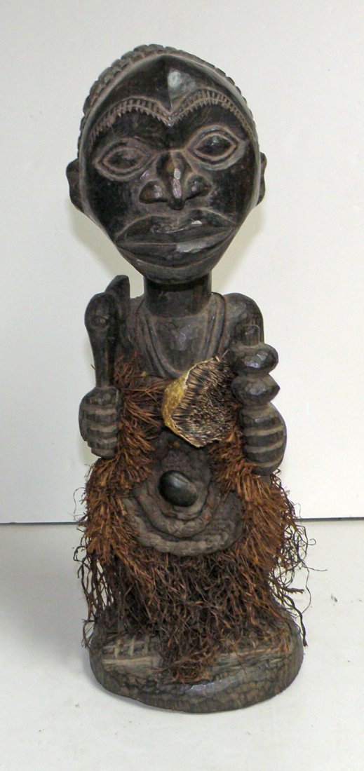 BEMBE WARRIOR STATUE: This is a shrine figure used by the Bembe for consultation during warfare. The skin of the porcupine on the chest was believed to carry magic powers and every warrior would pluck off one throne for pr