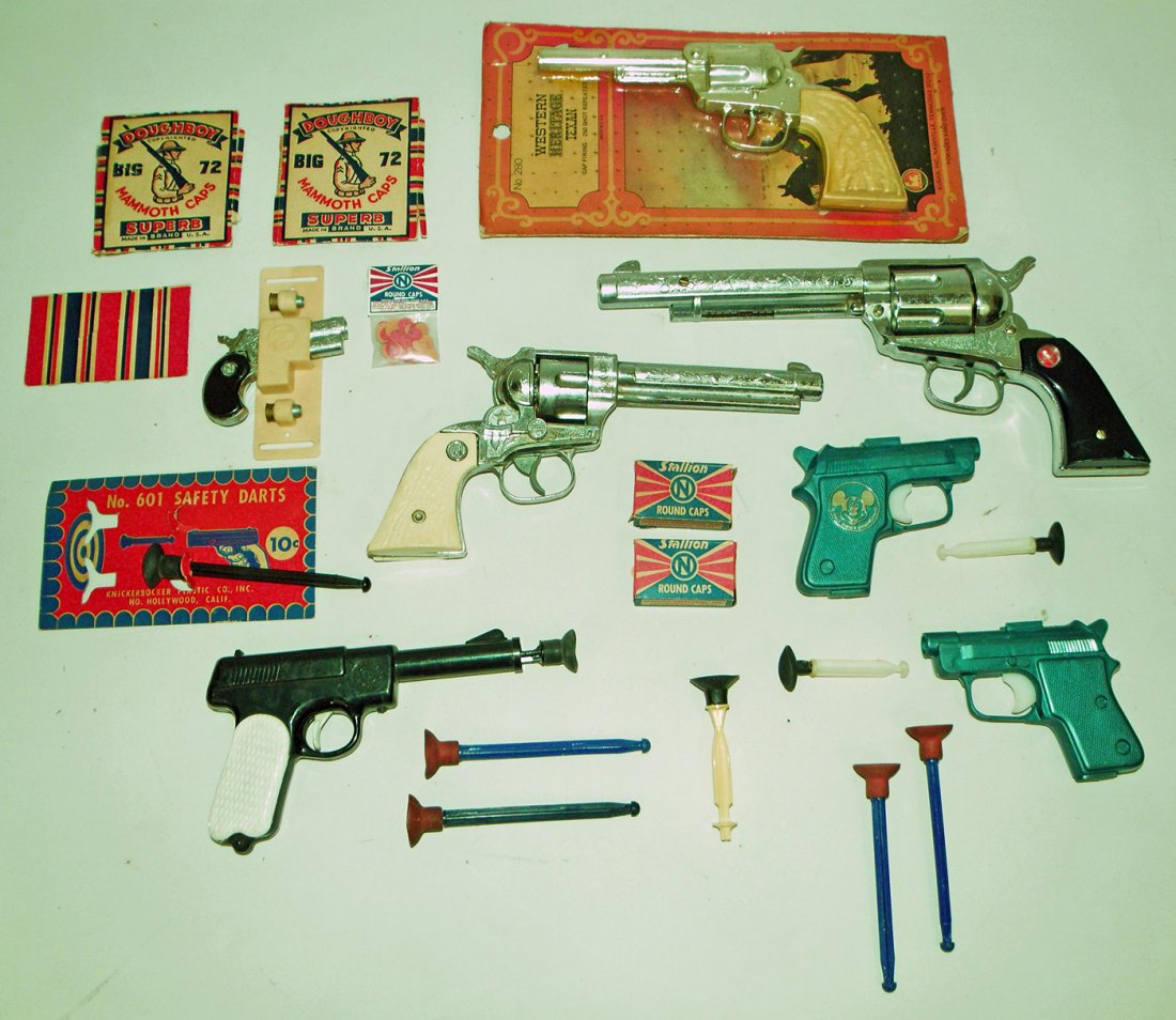 TOY GUN LOT: Includes carded Western Heritage Texan Cap Gun, Nicols Stallion .45, Nicols Stallion .38, and three dart guns, etc., all but one dart gun working. Varies