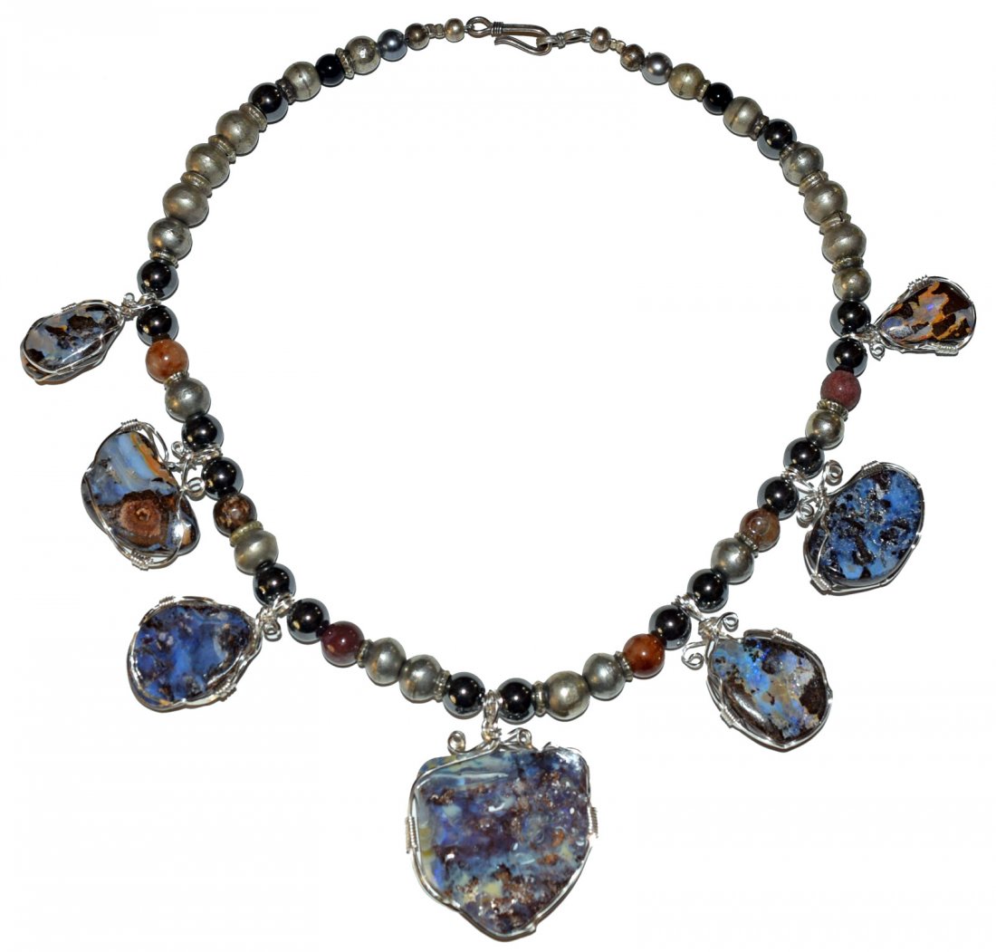 CUSTOM MADE OPAL SQUASH BLOSSOM NECKLACE.: 368 carat total - boulder squash blossom, has seven silver wrapped boulder opals. Neckless uses hematite stones, Turkomen silver beads and cornelian roundels.
