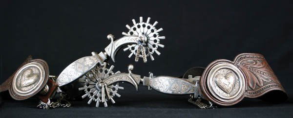 Ernie Marsh T.C.A. Card Suit Spurs: Silver inlaid "Card Suit" pattern, California style spurs feature inlaid heart, club, diamond and spade on the band, engraved inlaid shanks, heelchains, stylized 2 1/2"-16 pt rowels, silver inlaid jin