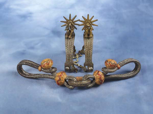 Fancy Hobbles and Iron Spurs: a) Braided leather hobbles with stylized oversized natural buttons highlighted with red and black accents, two tone rings; b) Unmarked Buermann style Ranger pattern iron spurs with tapered shanks, jin