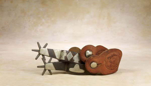 Impressive Texas Card Suit Spurs: Combining the styling of J O Bass and Kelly Bros, these spurs, marked "LOYD M" have spades, diamonds, clubs on 1/4" band & heart decorated swinging buttons. Tapered Bass style shank is 2 1/2" long and