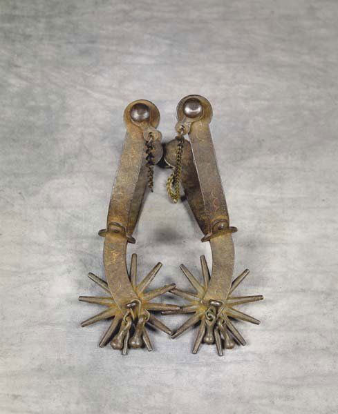 August Buermann #1218 Spurs: Patent marked with the 1877 and 1879 marks, 3"-12 pt rowels, with original attached jingle-bobs. Bands are the large 5/8" chased bent steel with 2 3/8" riveted shanks