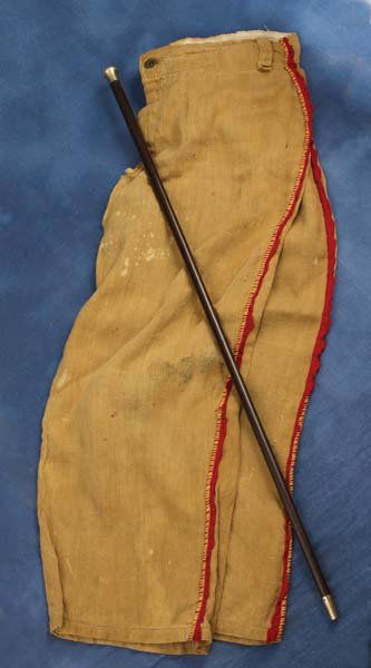 Costume Trousers: Muslin with red fringe seam, 26" long, originally came with a jacket that has been lost. This was a piece of a child's Indian set that was given by his Aunt Annie Oakley to Don Blakeley, who wore this