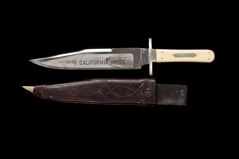 IXL California Bowie Knife: Etched 8” clip point blade boldly marked “Geo Wostenholm & Sons Celebrated California Knife”. The ricasso marked “G. Wostenholm & Sons IXL”. Overall knife is 12 1/4” with ivory slab grips 