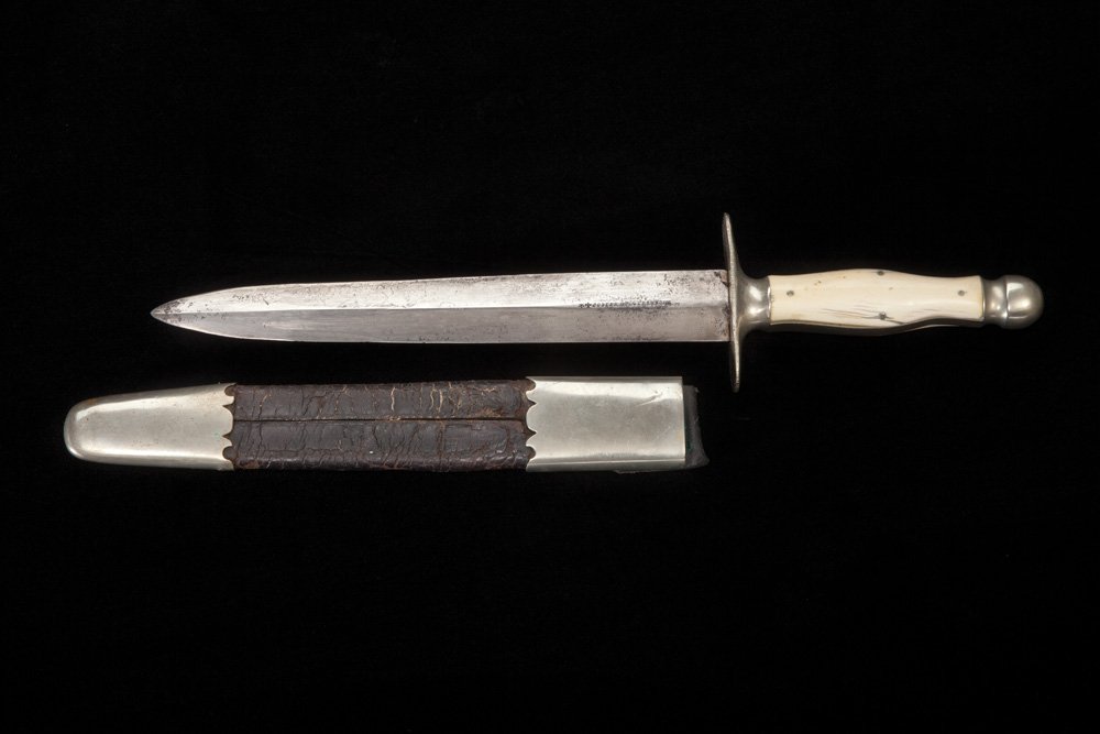 Joseph Rogers & Sons Bowie Knife: Unusually large dagger style bowie with full double edge 9” blade. Handles are 2 piece ivory grips attached with 4 silver pins and a rounded nickel pommel. The crossguard is 3” across with filed e