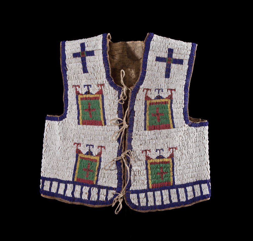 Northern Plains Child’s Vest: Circa 1900-1910 beaded vest with crosses and banners in blue, red, green, and yellow on a white field.