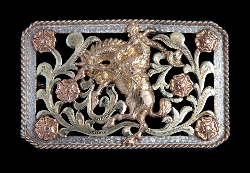 Bohlin 3-Color Gold Filigreed Buckle: No. 382 let ‘er buck (horse & rider), 3-color gold, rectangular buckle, measuring 2” x 3 1/8”, with 14K yellow gold, 3-dimensional rider, and twisted rope edge, six pink gold flowers, and green 
