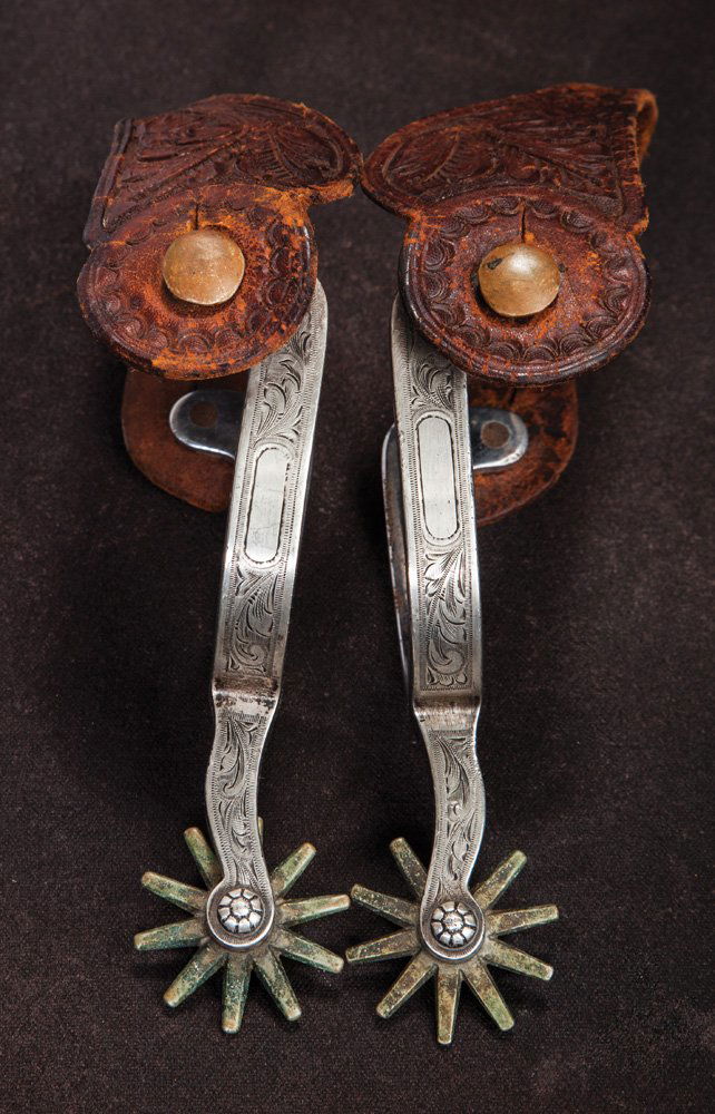 Edward H. Bohlin Mounted Crockett Spurs: Crockett stainless, narrow band spurs, with sterling overlaid, and finely engraved mountings attributed to Edward Bohlin as clearly evidenced by the use of Bohlin’s trademark silver spots as rowel p