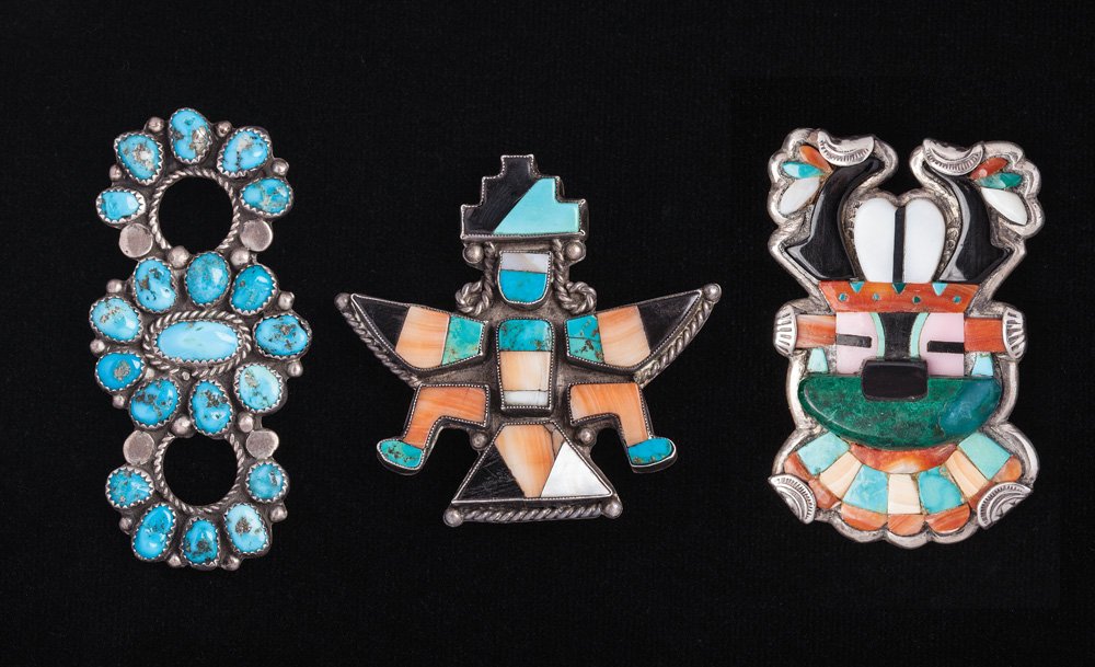 Lot of 3 Zuni Jewelry Items: a) Antelope dancer scarf slide, c. 1930s; b) Knife wing pin or slide, c. 1940s; c) Pin with 20 pieces of turquoise, c. 1940s.