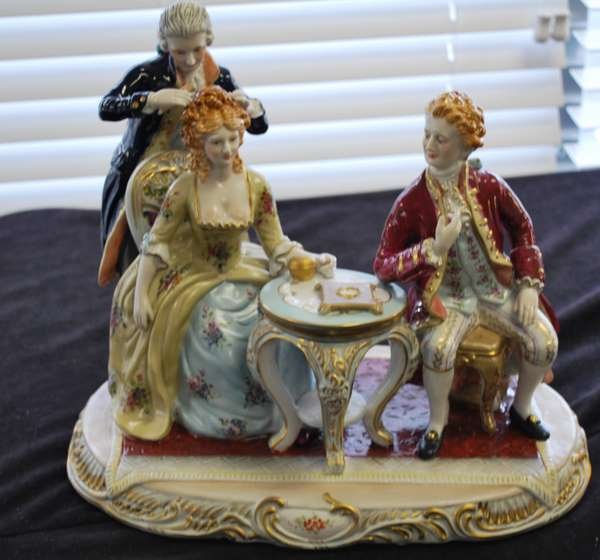DRESDEN PORCELAIN GROUPING: 20th CENTURY CONTINENTAL PIECE DEPICTING TWO ARISTOCRATS & A LADY'S HAIR DRESSER, SOME DAMAGE TO TABLE TOP, MISSING SMALL PIECE, BUYER ARRANGES SHIPPING, WE CAN RECOMMEND LOCAL SHIPPERS.
