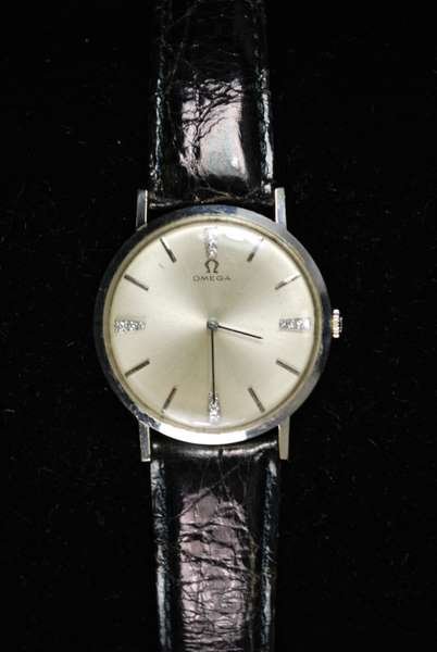 14KT W.G. OMEGA DIAMOND WATCH: MANUAL WIND CIRCA 1960'S ORIGINAL OFF WHITE DIAMOND DIAL COMES ON BLACK CROCODIAL STRAP APPROX. 34MM CASE, SHIPPING WILL BE ADDED.