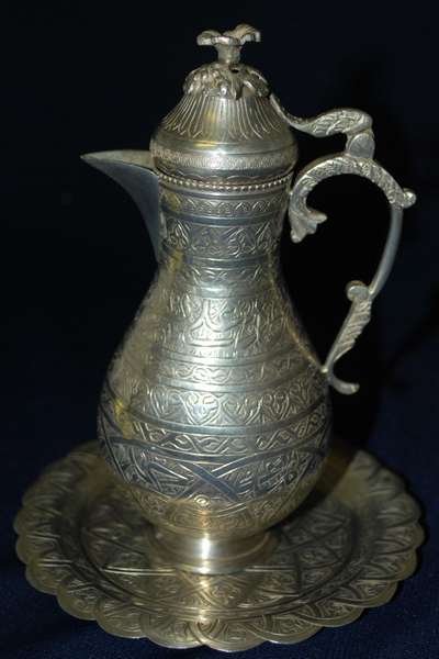 1890's MIDDLE EASTERN SILVER COFFEE POT & TRAY: VERY ORNATE POT WITH MATCHING TRAY, WONDERFULLY CHASED DESIGNS, BOTH PIECES HALLMARKED, POSSIBLY TURKISH OR PERSIAN, COFFEE POT SITS 6.5" HIGH, 5.5" TRAY DIAMETER, WEIGHS APPROX. 10oz BUYER ARRANGES S