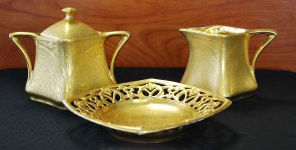 NOVEAU STYLE CREAM & SUGAR LOT: 3 GOLD PAINT OVER CERAMIC PORCELAIN PIECES, ONE CREAMER, ONE SUGAR, AND ONE NON MATCHING BAVARIAN TRAY, SUGAR HAS LID, BUYER ARRANGES SHIPPING, WE CAN RECOMMEND LOCAL SHIPPER.